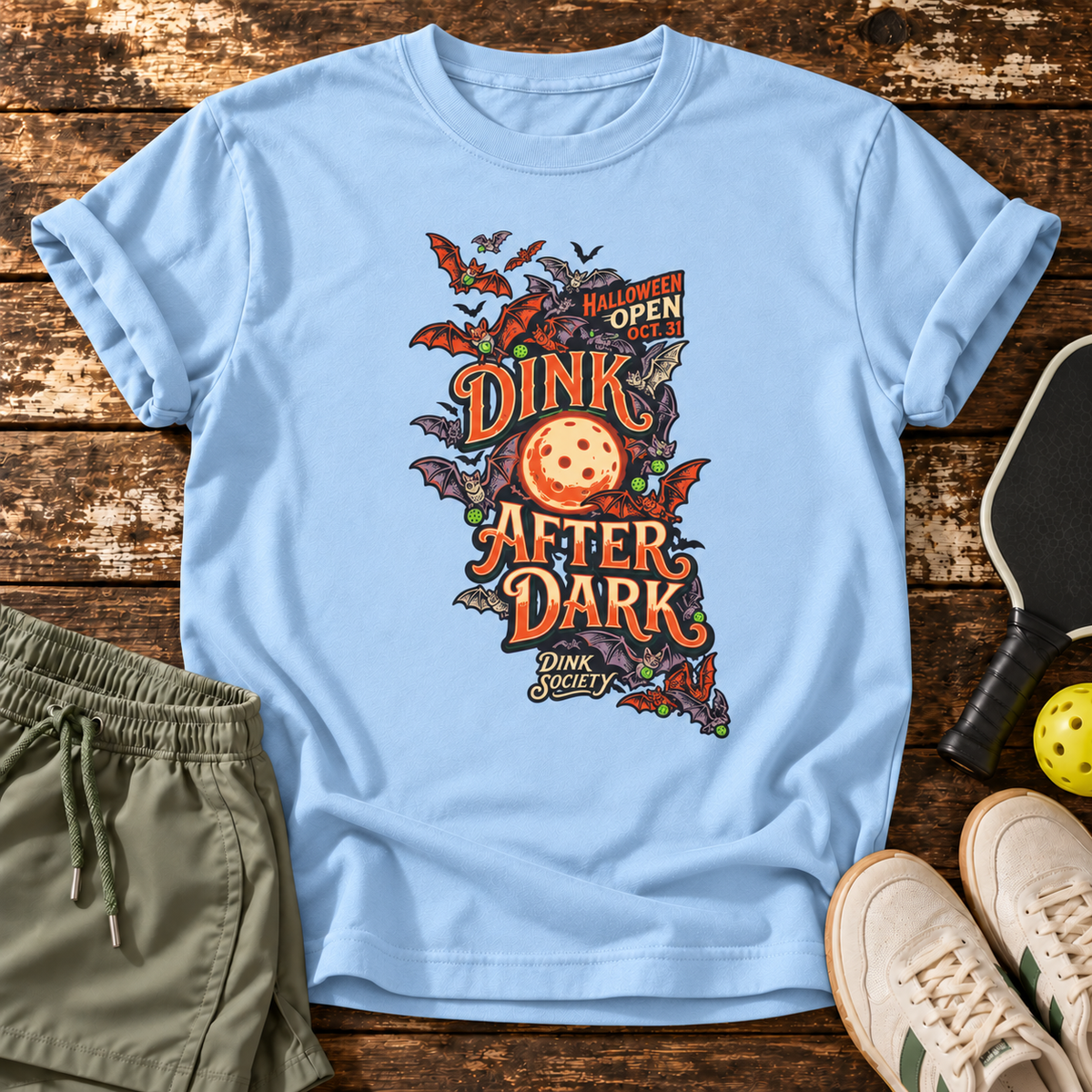 Dink After Dark T-Shirt — Light Blue — wooden flatlay
