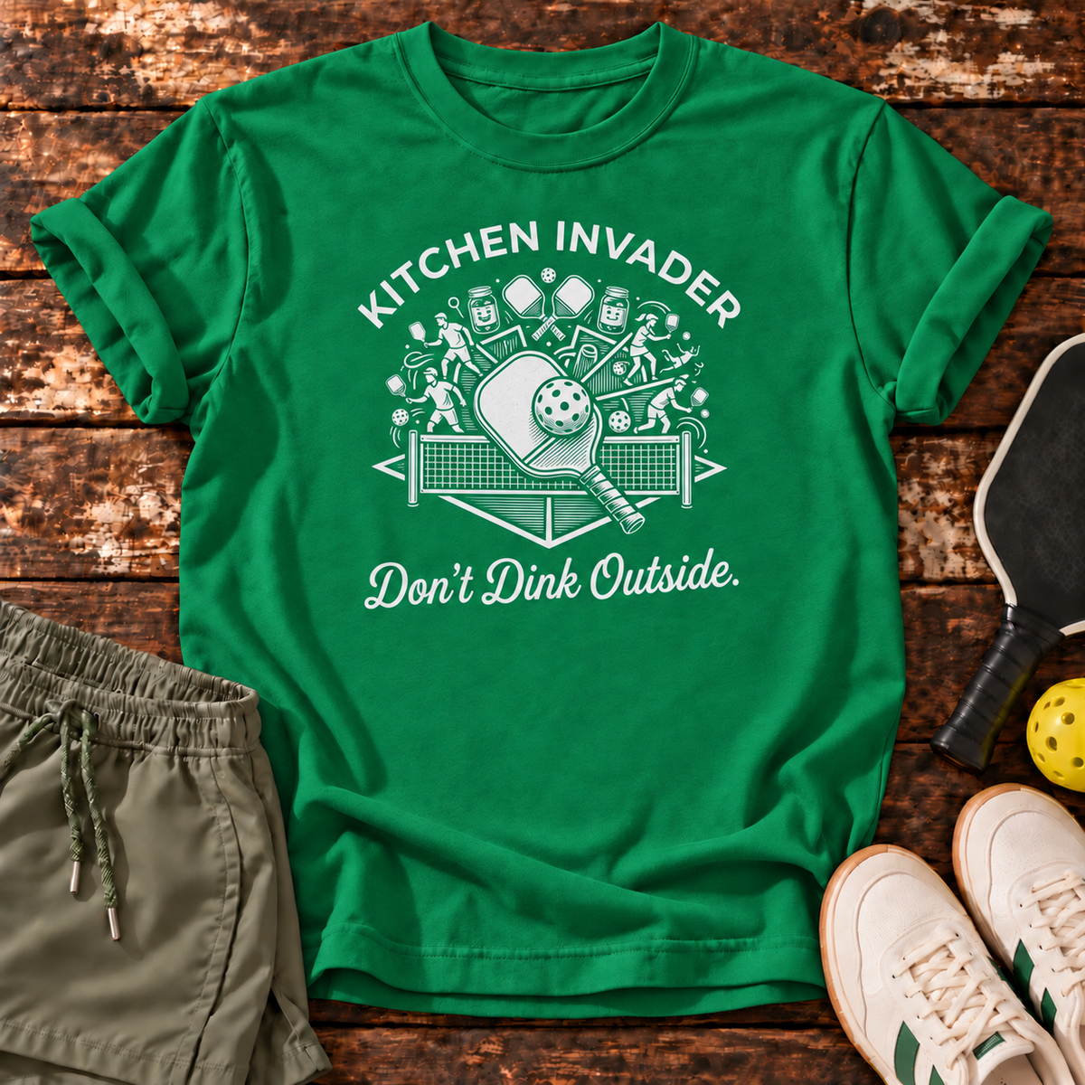 Kitchen Invader T-Shirt — Kelly Green — wooden flatlay